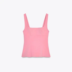 Rosa topp med rosett i ryggen - Supersöt rosa topp från Zara! Storlek M för en tajtare fit, passar även S. Använd fåtal gånger. Nästan ny! Inga tecken på användning!