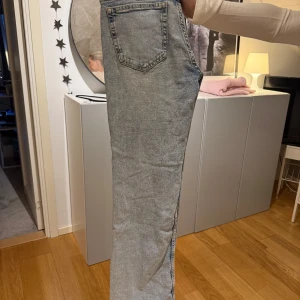 Ljusblå raka jeans - Säljer ett par ljusblå jeans med raka ben och klassisk femficksdesign. Jeansen har låg midja. Perfekta för en stilren look.
