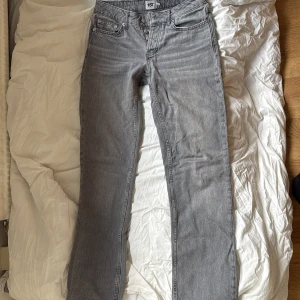 Grå raka jeans från 157, storlek XS - Snygga grå jeans från 157 i rak modell. Klassisk femficksdesign, knäppning med knappar och normal passform. Jeansen har en stilren look och är tillverkade i mjukt denimtyg som passar perfekt till sneakers eller boots.