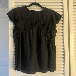 Svart blus med volangärmar - använd en gång 