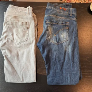 Dondup George Jeans - Säljer två par jeans, ett par klassiska blå och ett par ljusgrå. Båda har slitna detaljer och femficksmodell. Jeansen är i denim med snygg tvätt och passar dig som gillar en avslappnad och trendig look. Storlek 31 på båda paren. 1799 Styck!