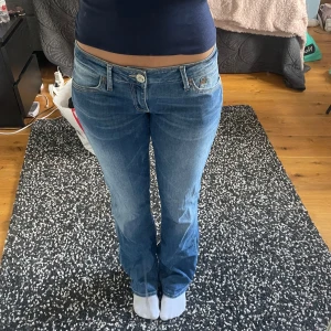 Blå bootcut jeans låg midja - Snygga blå jeans med låg midja och klassisk bootcut-passform. Jeansen har fem fickor, ljus tvätt och tydliga sömmar. Midjehöjd : 20 cm, midjebredd : 41 cm, innerbenslängd : 85 cm💕Kan inte hitta storleken på dem men dem passar mig som är S/M, W29💕