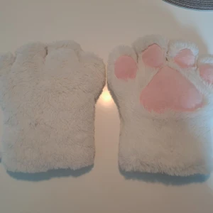 Vita fluffiga tasshandskar - Säljer ett par tasshandskar som jag köpte på Närcon! Används ett par gånger men är i bra skick. Ganska tjocka och bekväma! Båda handskarna är engkligen för vänster handen, men funkar bra ändå. Passar all händer skulle jag säga men har själv små händer ‼️Skriv om du har frågor ‼️