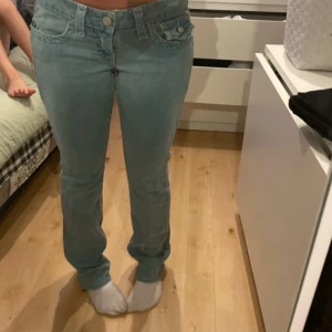 True Religion jeans joey - Säljer dessa true religion jeans jag köpt av en annan tjej på plick❤️ Jättesnygga men kommer inte till användning. Storlek 29. Passar bra på mig som är 167,5. Släpar i marken t.om. Ända är att jag klippt hål inne i midjan som inte syns så man kan trä ett skosnöre så de passar böttre i midjan 💞  Vet inte riktigt modellen men gissar på joey de är bootcut/straight.