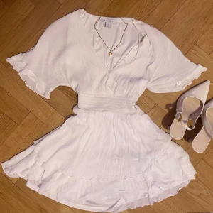 Kort vit klänning / vit skolavslutnings klänning / studentklänning/ sommarklänning  - Kort vit klänning med omlott v ringning och lösa korta ärmar med fin volang nedtill 💕 Kan inte skicka bild på då den inte passar☺️ Från märket amisu, skriv till mig om mått osv🤗kolla in vad mer jag säljer och gör gärna ett bundle och för att få 10% rabatt!☺️