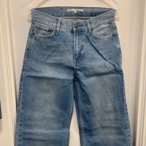 Blå wide leg jeans från Junkyard - Säljer ett par ljusblå wide leg jeans från Junkyard. Byxorna har klassisk femficksdesign, hög midja och raka, vida ben. Perfekta för dig som gillar en avslappnad och trendig stil.