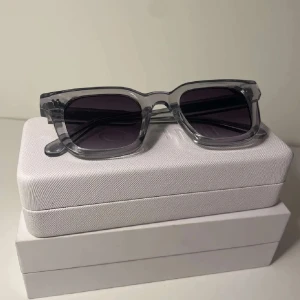 Chimi 04 GREY - Feta glajor från CHIMI med transparenta bågar och mörka linser. Stilren och modern design som passar perfekt till sommaren. Säljer då jag köpt fel modell. Kommer med allt original, som nya. Prutat o klart. Kom gärna med frågor.