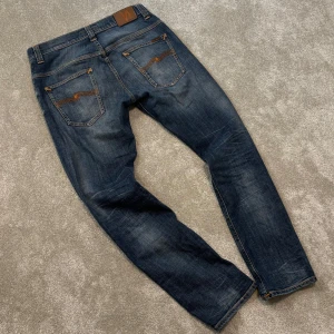 Nudie Jeans - Tjena! Säljer dessa feta blå Nudie jeans med schysst tvätt! Jeansen är i fint skick och är utsv modellen ”Thinn Finn” och har en slim/straight passform. Size 32/32. Skriv vid funderingar!
