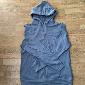 Ljusblå hoodie från 157 - Säljer en enkel och stilren ljusblå hoodie från 157 i storlek M. Tröjan har huva med dragsko och långa ärmar samt mjuk insida. Perfekt för en avslappnad look.