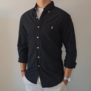 Ralph Lauren Skjorta - Stl S, Slim Fit - Hej säljer en fin Ralph Lauren skjorta I färgen Svart, Perfekt till sommaren! 🏖🏝 |Skick: 9/10 | Stl: S, Slim fit | Han på bilden är 172cm | Fraktar spårbart med Instabox eller Postnord | Mvh Galgen 🤗