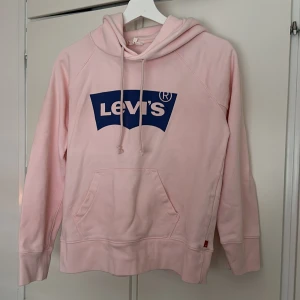 Ljusrosa hoodie från Levi's XS - Använd max 3 gånger. Älskar färgen. .3! Är aningen ljusare i verkligheten, den perfekta babyrosa färgen. Men använder aldrig hoodie, därav säljer jag den. 
