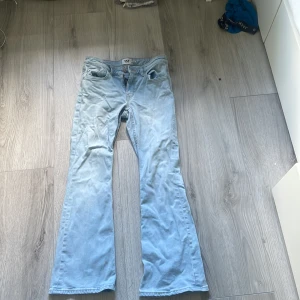 Bootcut ljusblå jeans från 157 - Säljer ett par ljusblå bootcut jeans från 157 med låg midja. Är en liten fläck på ena benet syns knappt 