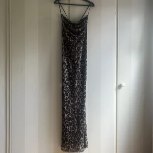 Leopardmönstrad långklänning med tunna axelband - Säljer en långklänning med leopardmönster och tunna axelband. Nästan aldrig använd 