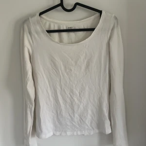 Vit långärmad topp från 157 - Säljer en enkel och stilren vit långärmad topp från 157 i storlek XS. Tillverkad i mjuk bomull med lite stretch för en bekväm passform. Perfekt att matcha med jeans eller kjol för en clean look.
