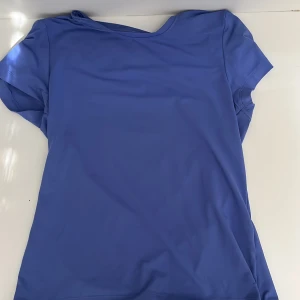 Blå tränings t-shirt från Energetics - Säljer en blå t-shirt från Energetics. Perfekt för träning eller vardagsbruk. T-shirten har en enkel design med korta ärmar och rund hals. Materialet känns mjukt och bekvämt mot huden.