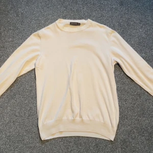 Beige tröja från Oscar Jacobson - Säljer en stilren vit tröja från Oscar Jacobson. Använd ett fåtal gånger utan skador! Nypris: 1300  mitt pris 800    (Strl S)  om intresserad skriv!⭐️ 