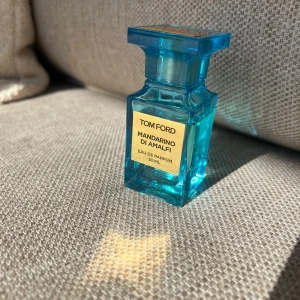  Tom Ford Mandarino di Amalfi Eau de Parfum - Fräsch och lyxig parfym från Tom Ford i doften Mandarino di Amalfi. 50ml flaska men använd, se bilder för mängd. Lite repor på flaskan samt nötts av lite av yttersta lagret på framsidan längst ner som endast ses i vissa ljus, gick ej och få med på bild. Äkta. 