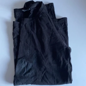 T-shirt - Svart fin T-shirt. Något längre bak. Diskret mönster fram stl 158/164