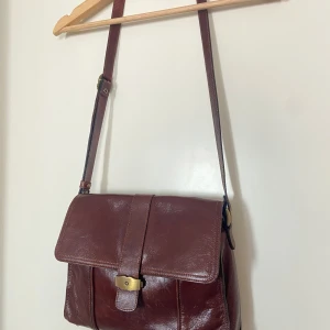 Crossbody väska i skinn - Brun skinnväska med justerbar rem från Three Bags of Finland.  30x21x8.  