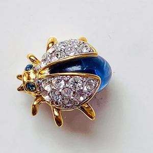 Brosch  - Liten brosch i form av glittrig skalbagge med blå rhinestone