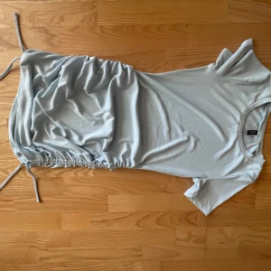 Klänning  - Super super fin ljusblå klänning från hm!! som man ser på bilden kan man styra hur kort eller lång man vill ha den. Användt den fåtal gånger och den är fortfarande i lika bra skick som när jag köpte den!! Den är i stolek S men passar L!! 