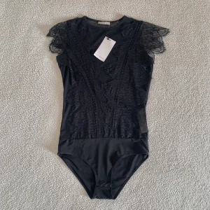 ZARA spetsbody med mesh - Otroligt snygg body från ZARA i spets och mesh. Utan anmärkningar, ny med tags kvar. Stretchig och bekväm och normal i storleken.