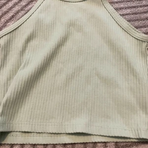 mintfärgat linne  - Snyggt och enkelt att ha. Knappast använd ❤️ strl 134/146 och väldigt fin! står ej för frakt och den tvättas inte innan. 