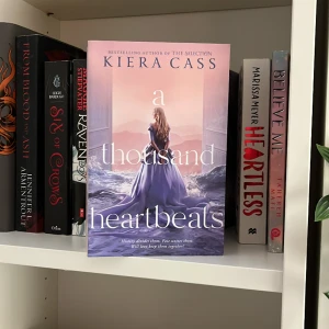 Booktok - A thousand heartbeats av författaren som skrivit The selection. Oläst skick