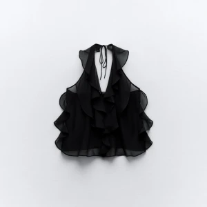 zara topp - Säljer denna snygga halvtransparenta topp med volanger och öppen rygg från zara då den inte kommer till användning. Endast använd en gång så är som ny🥰