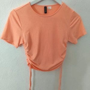 T-shirt med dragsko - Ljusorange från H&M. Köpt secondhand. I bra skick. 