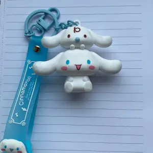 Den är äkta sanrio licensierad och är köpt utomlands i Miniso. Den är ca 5-6 cm i höjd så den är ganska stor. Det är Cinnamonroll. Den är vit så den blir ”smutsig” ganska lätt, men ”smutsen” går lätt av.