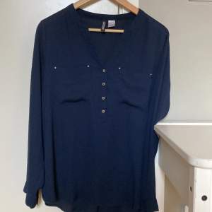 En marinblå lätt transparent skjorta från H&M i storlek 38. I väldigt fint skick. Från ett djur och rökfritt hem. 