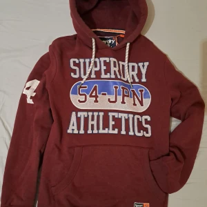 Superdry hoodie  - Säljer denna riktigt sköna superdry hoodie pågrund av att den inte kommer till användning. Den är använd men i bra skick. Bara att höra av sig vid frågor