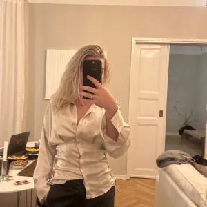 Zara blus med knyte i midjan  - Helt oanvänd prislapp kvar och medföljer.   Sidenmaterial  Färgen skulle jag säga är en blandning av naturvit/Beige/ grå med lite lite puderrosa färg  Storlek m men jag tycker den är lite liten på mig. Det 
