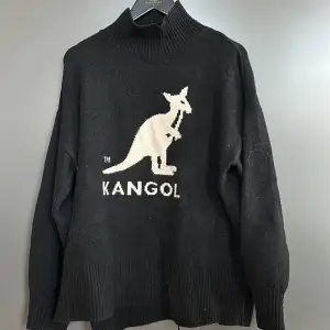 Svart stickad tröja från Kangol x H&M. Lite ”noppig” men annars bra skick. Slitsar nertill (se bild).