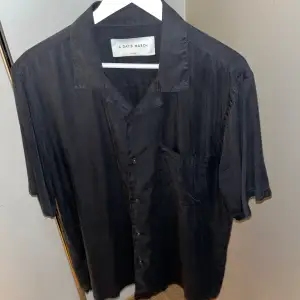 Yamu lyocell shirt i färgen off black. Säljes pga fel storlek. Inköpt sommaren 2023 och är i fint skick. Nypris 1000kr.