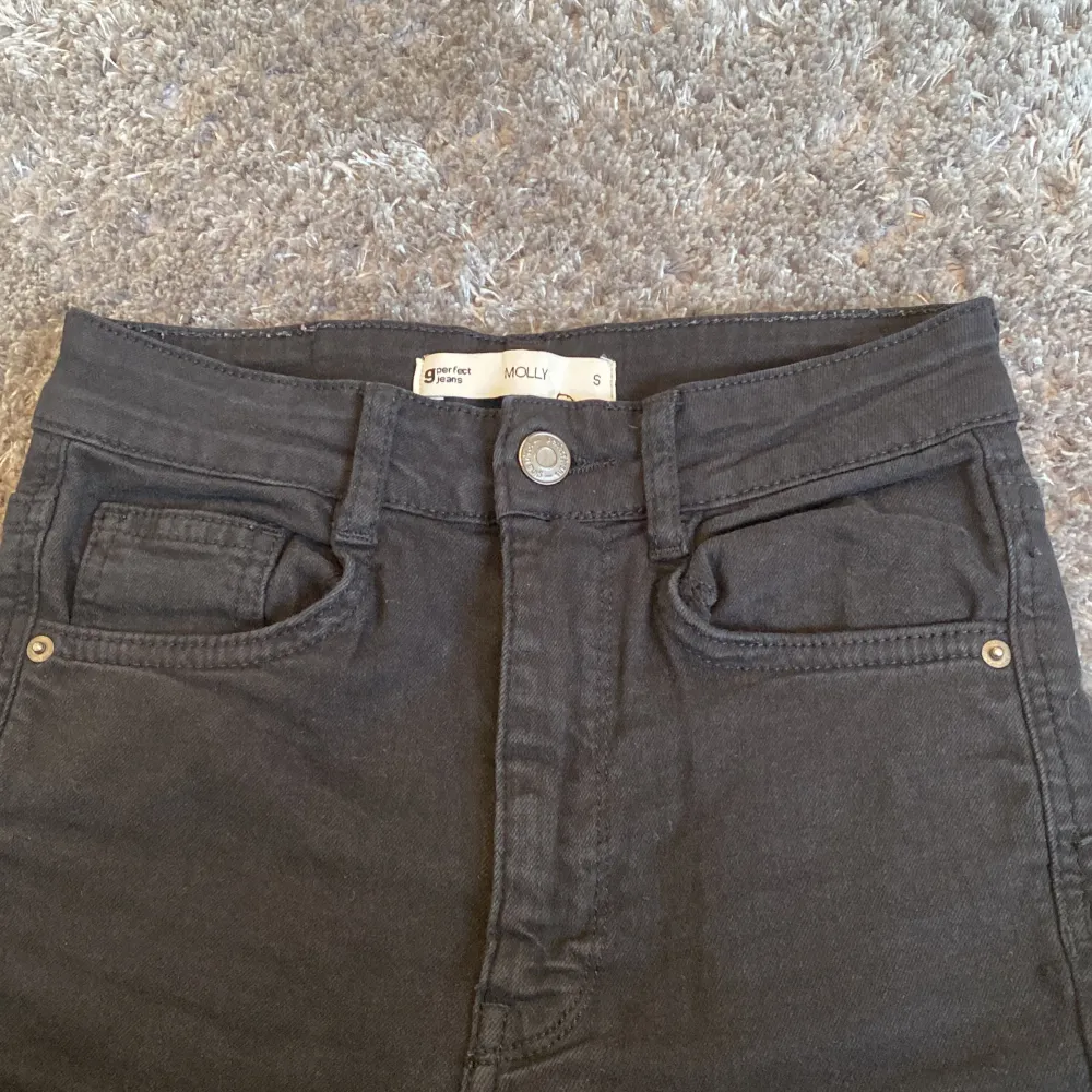 Svarta Molly straight jeans från Ginatricot och har slitsöppning vid ankeln. Storlek S. Köptes för 399 kr och säljer för 100kr.. Jeans & Byxor.