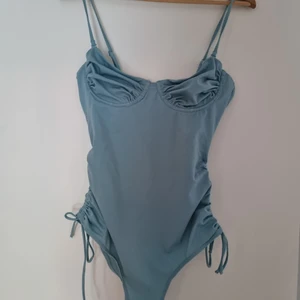 Oanvänd baddräkt från Monki - En baddräkt i storlek M från Monki. Oanvänd. Passar mej som är M och c-kupa. Reglerbart axelband och banken på höften/midjan går också att reglera.  Skickas för 49:- via skicka lätt eller hämtas i Järfälla.