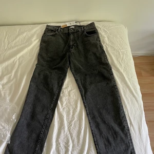 Gråa Jeans - Säljer mina helt oanvända trendiga mörkgråa Woodbird jeans då storleken inte passade mig. De är köpta för 999kr på 2trendy.se De är i en avslappnad model och storleken 32/32. Finns kvar om inte markerad som såld!!!