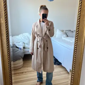 Så snygg beige trenchcoat i lagom längd!! Perfekt nu till hösten med en stickad tröja under. Från STOCKH LM 🦋 Stl 36