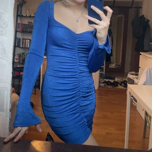 Blå festklänning  - Väldigt fint blå festklänning! Långa ärmar och otroligt fin passform. Aldrig använd och lappen sitter kvar!