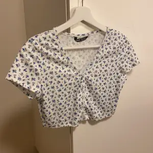 Supersöt croppad tshirt med små blåa blommor. Aldrig använd