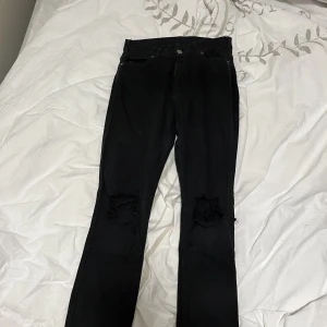 Svarta jeans  - Svarta tajta jeans med hål på knäna. Väldigt stretchiga material. De är i storlek m men skulle personligen säga att de är ganska små så snarare s. Dock är det bra med stretch så passar mig som vanligtvis har m💕