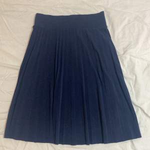 Marinblå, plisserad kjol i storlek S. Endast använd 1 gång!