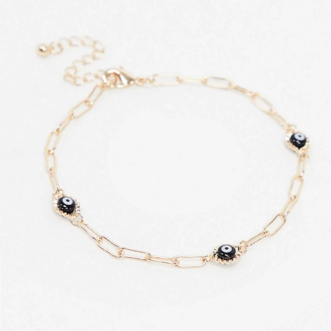 Guldfärgad fotlänk med ögonberlocker  - 90