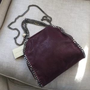 Stella McCartney liten tote - Jättefin skick, inga anmärkningar Stella McCartney falafella liten totebag i färgen Burgundy. Först till kvarn.  Har ingen dustbag till. 