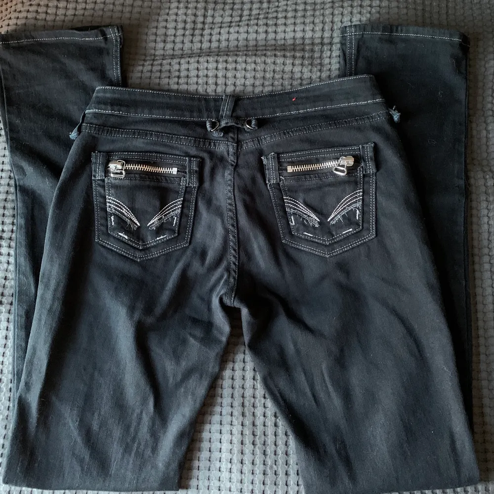 Lågmidjadw svarta jeans köpta second hand i storlek 29 motsvarande 36/38☺️ Silverdetaljerna på bakfickorna och de gråa sömmarna gör allt!🤍. Jeans & Byxor.