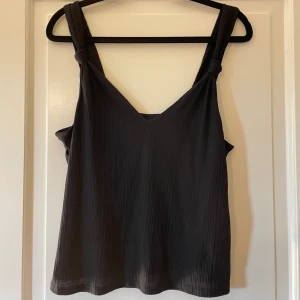 Svart linne med knytdetaljer - Ett svart linne med knytdetaljer på banden 💗Storlek M från H&M 