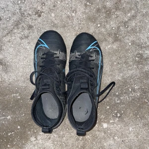 Fotbollskor - Ett par svart blå nike fotbollskor! Fint skick🤩