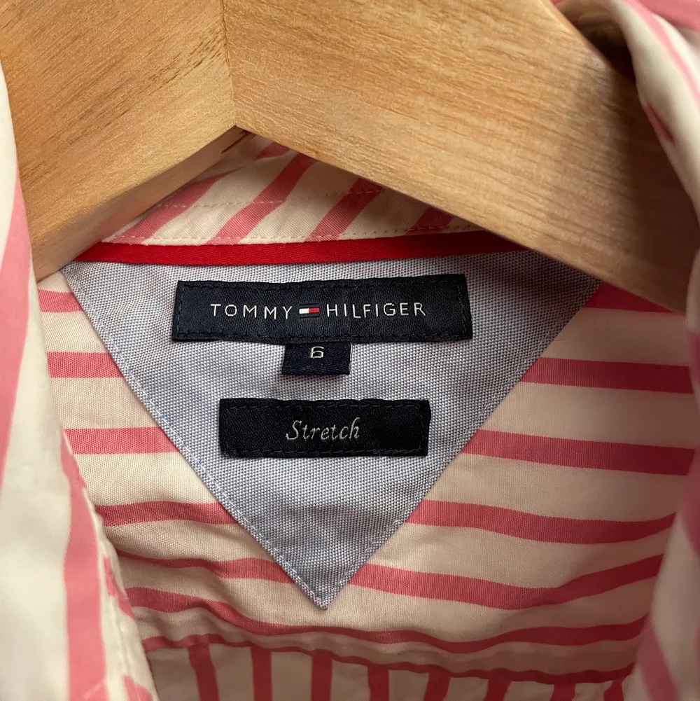 Äkta Tommy Hilfiger skjorta med fina reversibla detaljer, marinblå och rosa ränder. Jättefint skick, som ny. Storlek XS-S, säger stretch men jag tycker att den sitter tajt.. Skjortor.